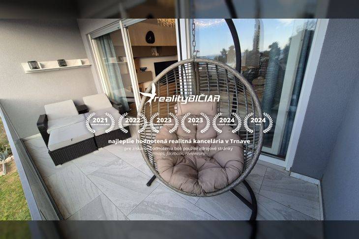 Relaxation terrace of a recreational apartment with a round hanging chair and rattan seating.