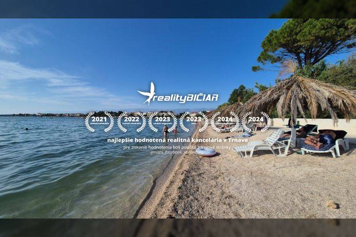 A sandy beach by the sea with loungers under straw umbrellas, clear sky, and calm water.