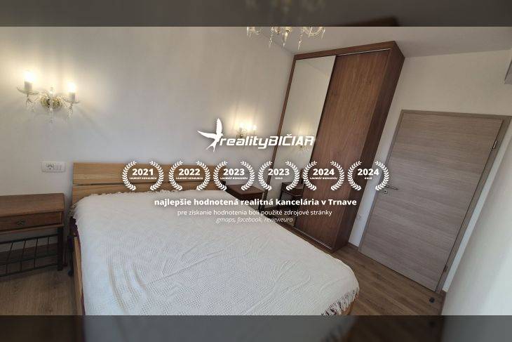 Recreational apartment with a comfortable bed and wooden decor flooring, illuminated by wall lamps.