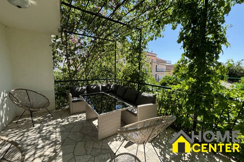 The terrace of a family house in Čiovo with comfortable seating and greenery for a pleasant sitting experience.