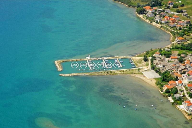 Aerial view of the coast of the town Ljubač with a harbor and houses along Ljubač street.