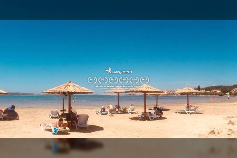 A beach with loungers and umbrellas by the sea in the town of Ljubač for living.