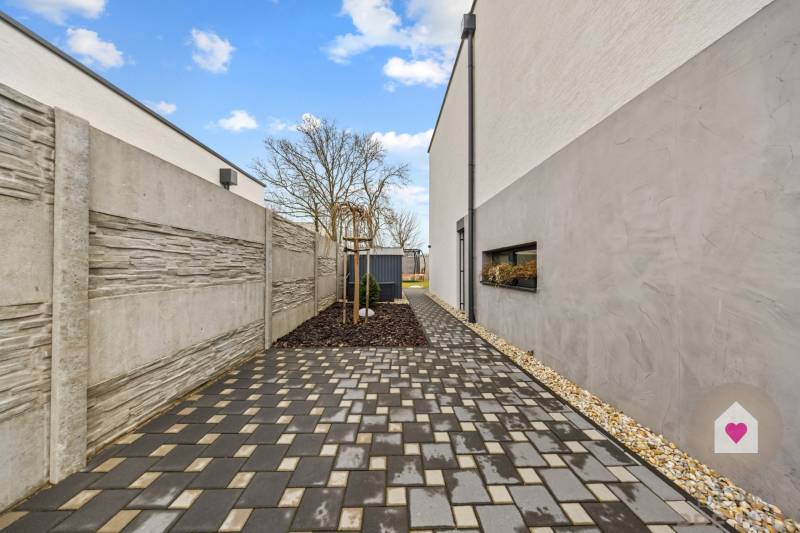Paved path along the house on Topoľová Street in Rovinka.