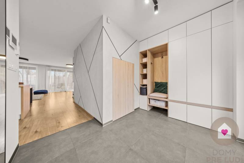 Interior of a 4-room apartment with wood-patterned flooring and built-in cabinets.