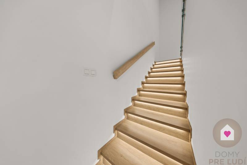 A staircase with a wooden decor floor and lighting in a 4-room apartment.