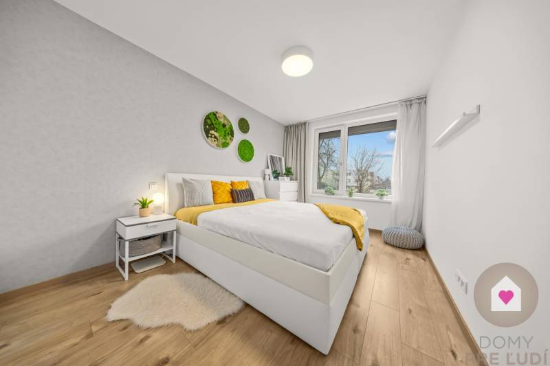 Bedroom with a bed and wall decorations, floor with wood decor.