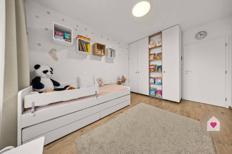 Children's room in a 4-room apartment with a bed, toys, and books, floor with wooden decor.