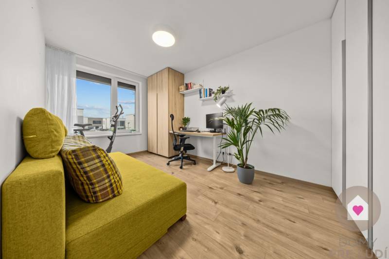 A study in a 4-room apartment with a decorative floor, a yellow sofa, and a large window.