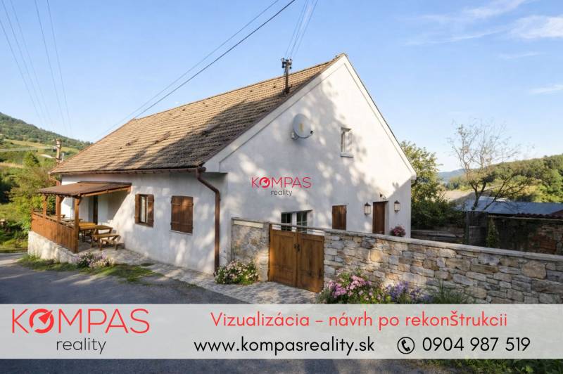 House by the road with a wooden terrace and flowers in the village of Vígľašská Huta-Kalinka.