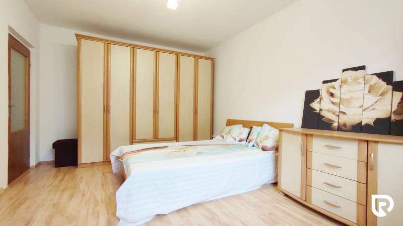 A bedroom with a bunk bed, wardrobe, dresser, and floor with a wooden decor in a two-room apartment.