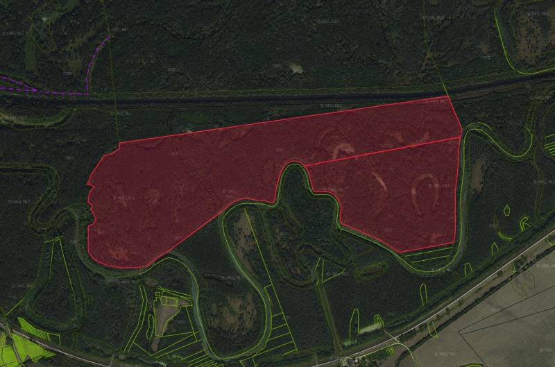 Aerial view of agricultural and forest lands around the town of Boľ.