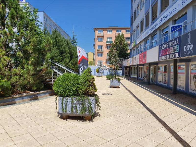Offices on Letná Street, Košice - Sever district, with greenery and shops.