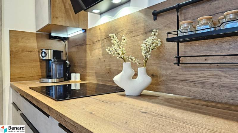 A kitchen unit in a studio apartment with a coffee maker and decoration in wooden decor.