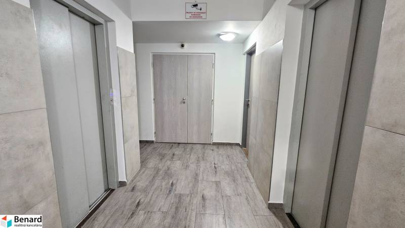 A corridor with two elevators and a floor with a wooden decor, Košice - Nad jazerom, Rovníková.