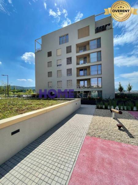 Residential complex on Zdenka Schelingová Street in Bratislava, Devínska Nová Ves, with greenery and a playground.