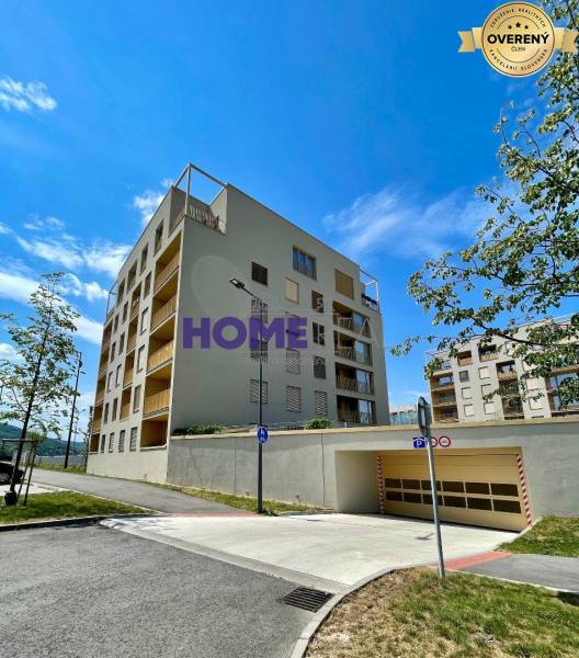 Apartment building on Zdenka Schelingová Street in Bratislava, Devínska Nová Ves, with a garage entrance.
