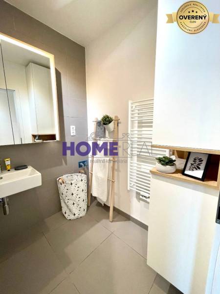 Bathroom with a sink, mirror, and white radiator in a 3-room apartment.