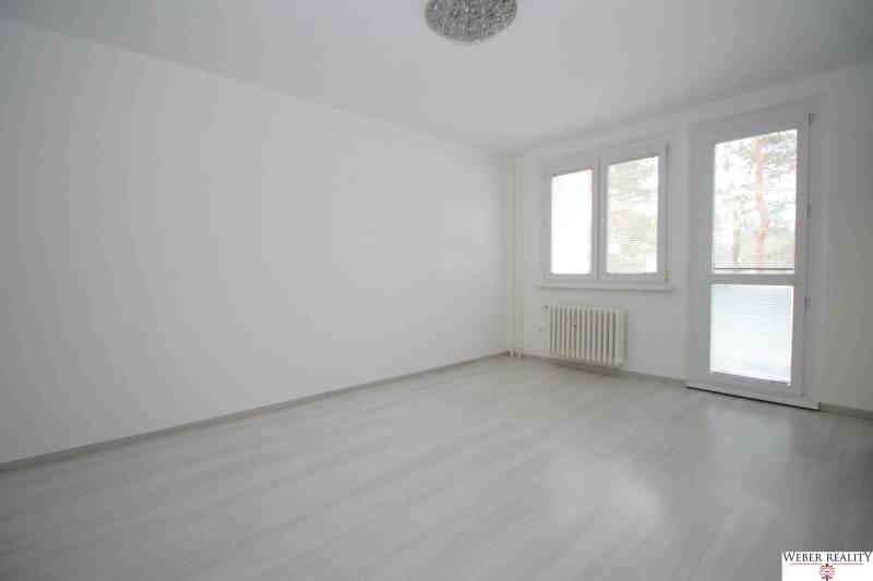 A room in a 3-room apartment with a wood-decor floor and large windows.