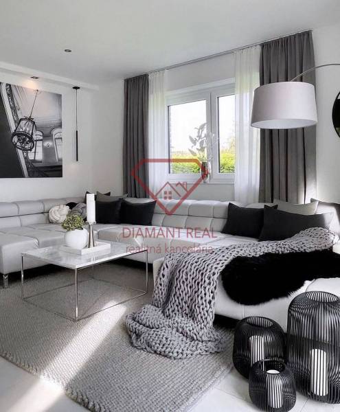 A stylish living room with a corner sofa and decorative elements in a three-room apartment.