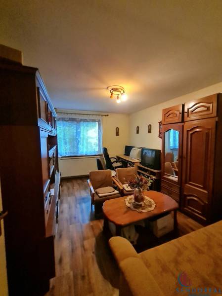 Living room in a family house with furniture and flooring featuring a wood design.