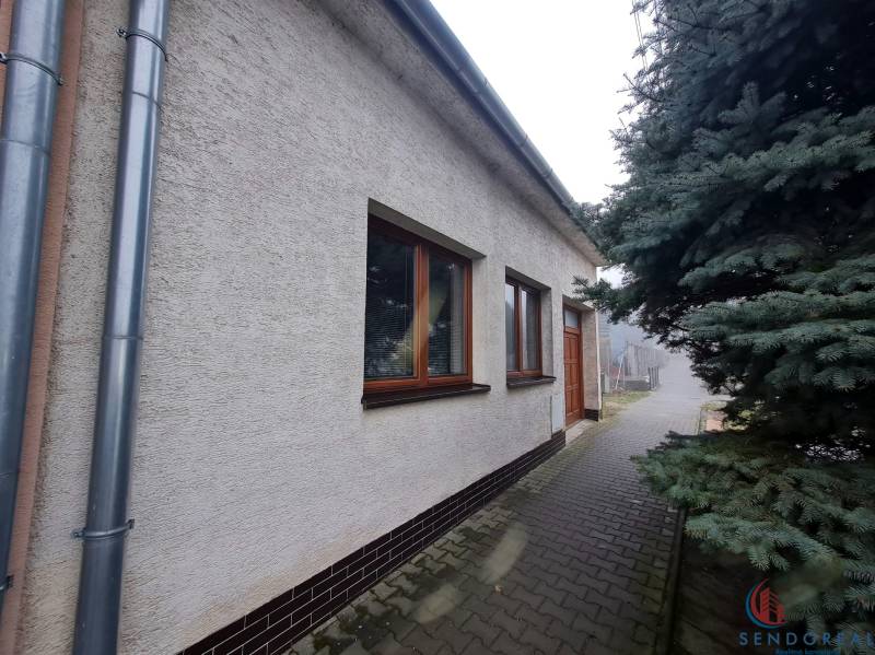 A family house on 1st May Square in Chtelnica with a landscaped exterior and a tree.