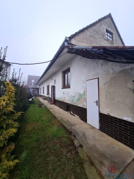 Family house on Námestie 1. mája in Chtelnica with a grassy yard and garden greenery.
