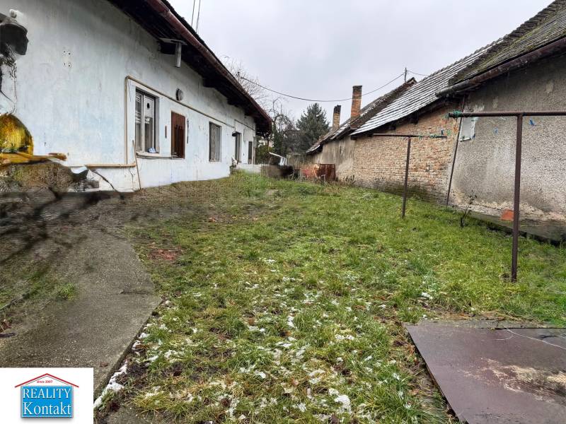 A family house with a garden on Komenského Street in Šurany, next to original buildings.
