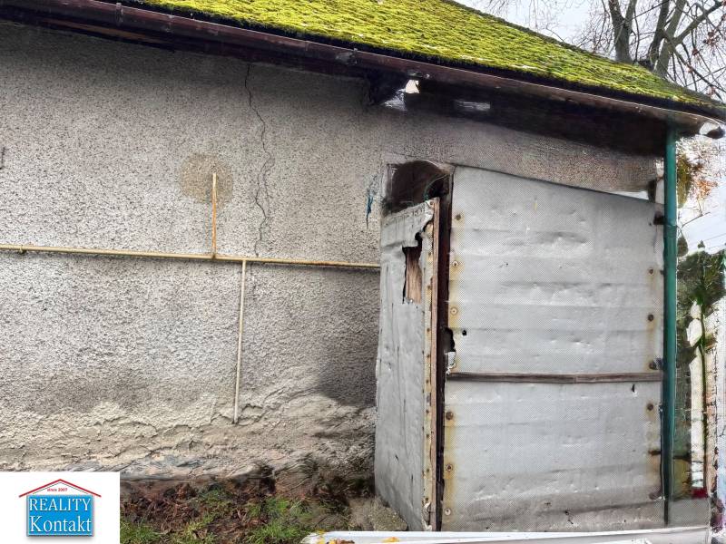 A family house on Komenského Street in Šurany with an older facade and moss on the roof.