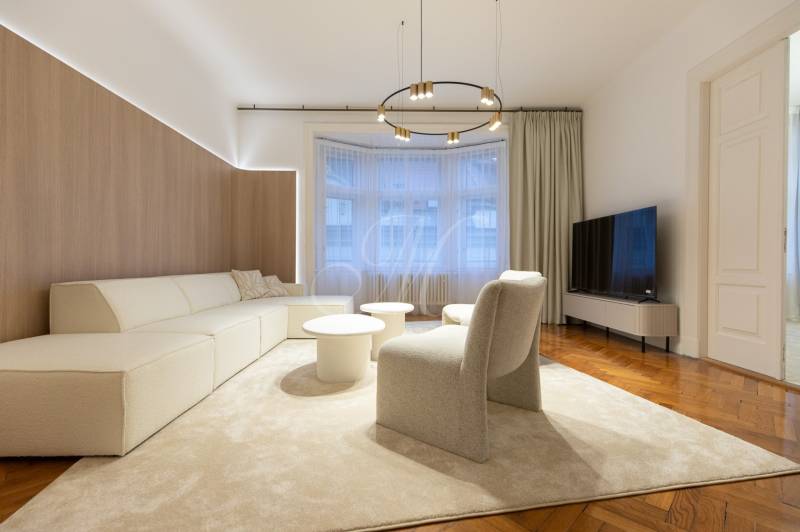 Elegant living room with a light sofa, round tables, and a floor with a wood decor.