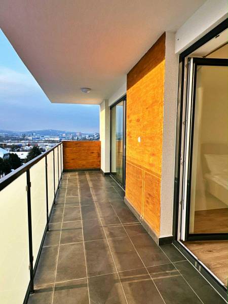 Balcony of a 3-room apartment with a view of Prešov, Solivarská 14, large glass doors.
