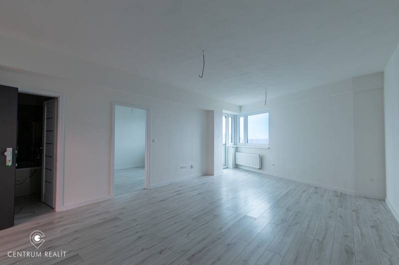 A bright interior with a wood-decor floor in a 2-room apartment.