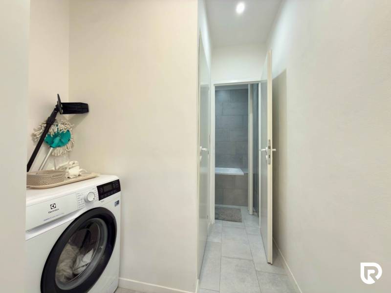 Washing machine in the hallway of a 2-room apartment with access to the bathroom.