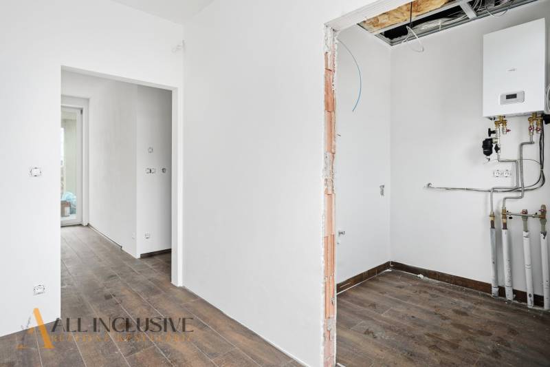 Interior of a family house with a wooden decor floor and heating equipment.