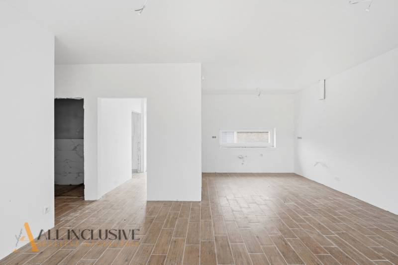 Interior of a family house with a wooden decor floor and white walls.
