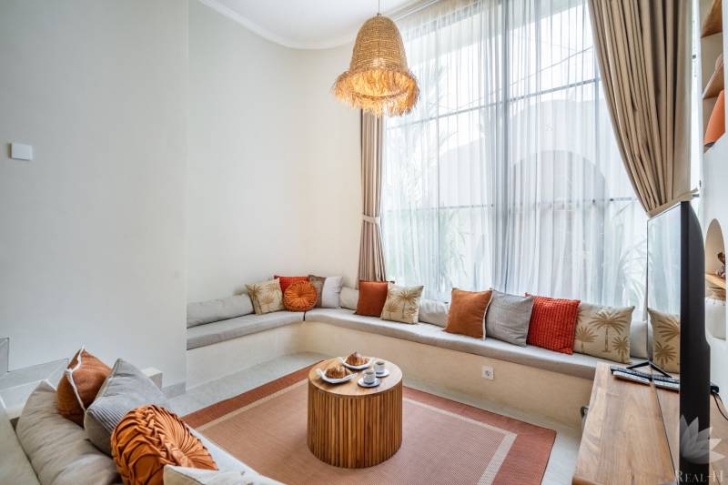 Comfortable seating with cushions and a wooden table in a cozy corner of the villa.