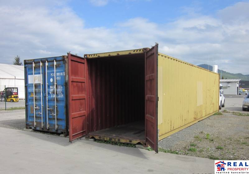 An open yellow container on Strojnícka Street in Prešov near warehouses and halls.