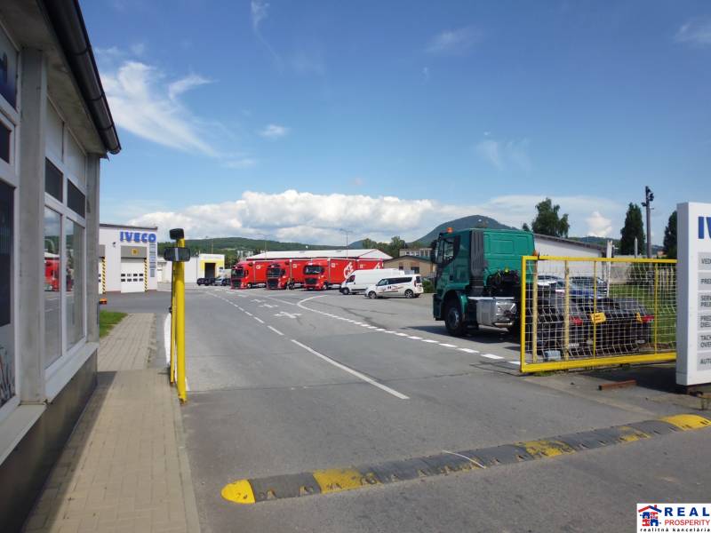 An area with trucks on Strojnícka Street in Prešov, near warehouses and halls.