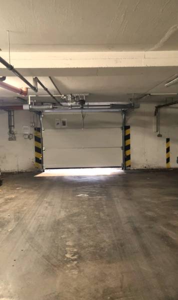 Garage building with a concrete floor and a garage door.