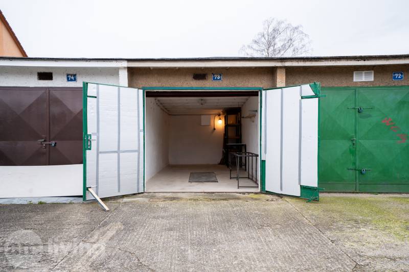 Open garage on Inovecká Street in Trenčín with interior lighting and shelves.