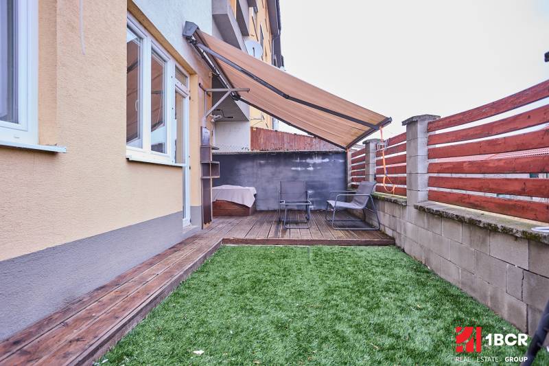Exterior of a 2-room apartment with a terrace and wooden decor flooring on M.R. Štefánika Street in Most pri Bratislave.