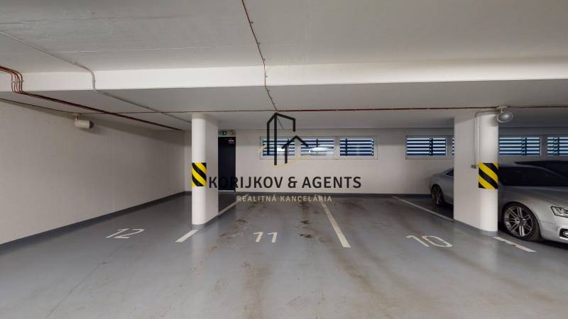 Underground garage with parking spaces and columns in the building on Strojárenská in Košice.