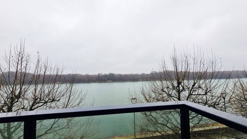 View of the river from the balcony, bare trees, gloomy weather, Dvořákovo nábrežie in Bratislava.