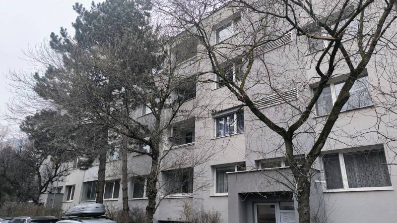 Apartment block with trees on Janotova Street in Bratislava - Karlova Ves.