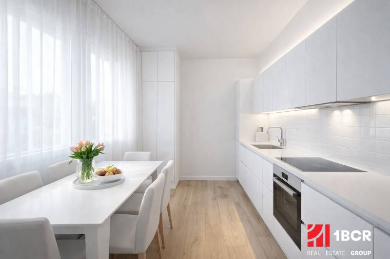 White kitchen with a dining table and a wooden decor floor in a studio apartment.