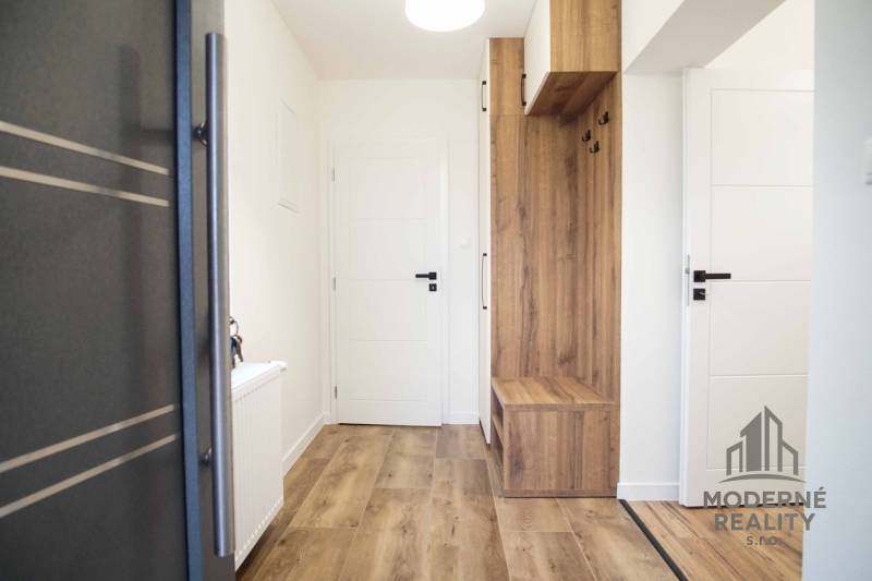 Interior of a family house with a wooden decor floor and built-in furniture.