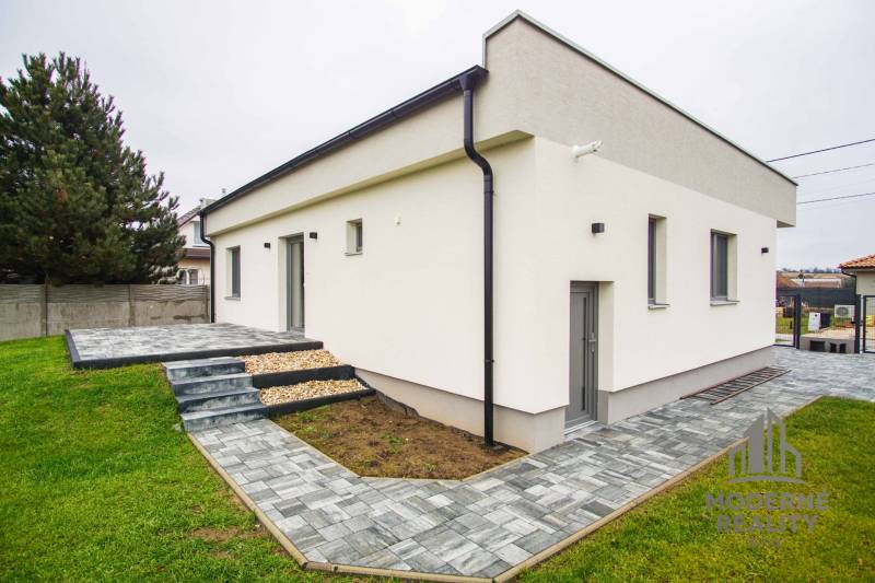 A family house in Branovo with a terrace, paved area, and green land.