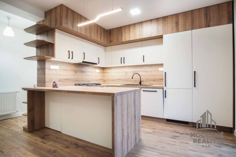 A kitchen unit with a wooden decor floor in a family house.