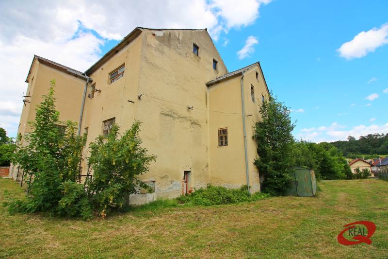 A building in Veľké Uherce surrounded by greenery and a grassy plot.