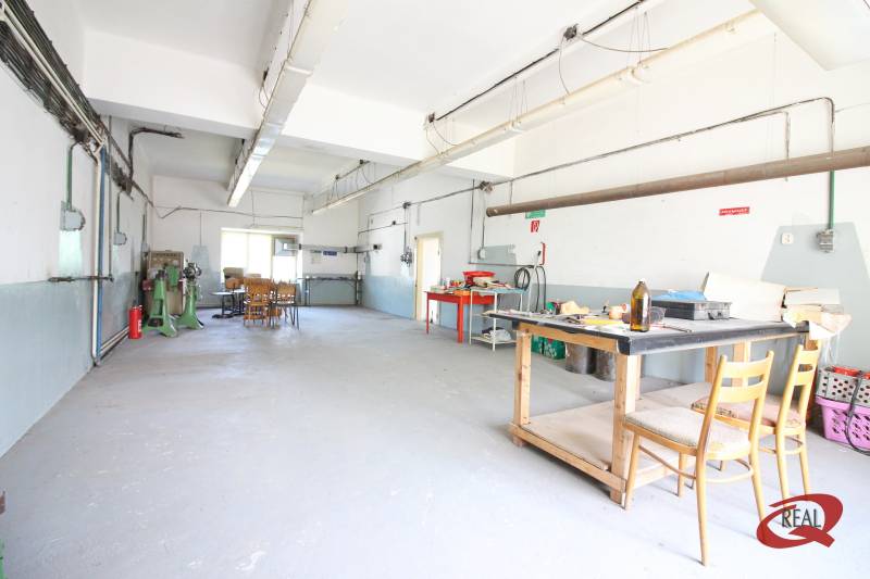 Industrial interior of a building with a desk and chairs.
