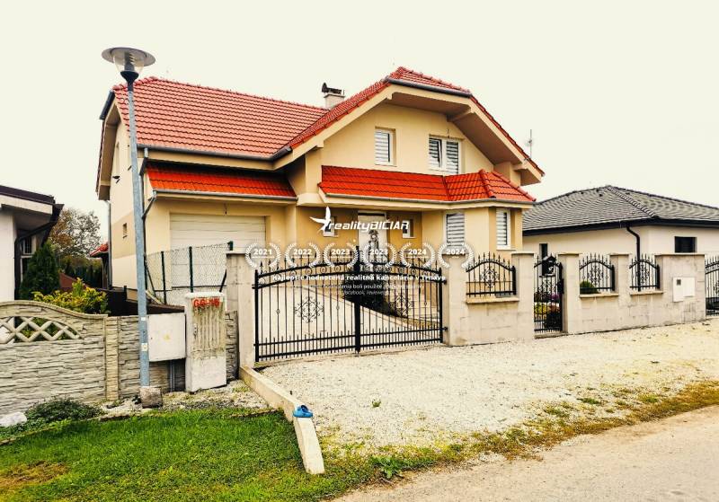 A family house in Ratkovce with a red roof and a landscaped exterior.